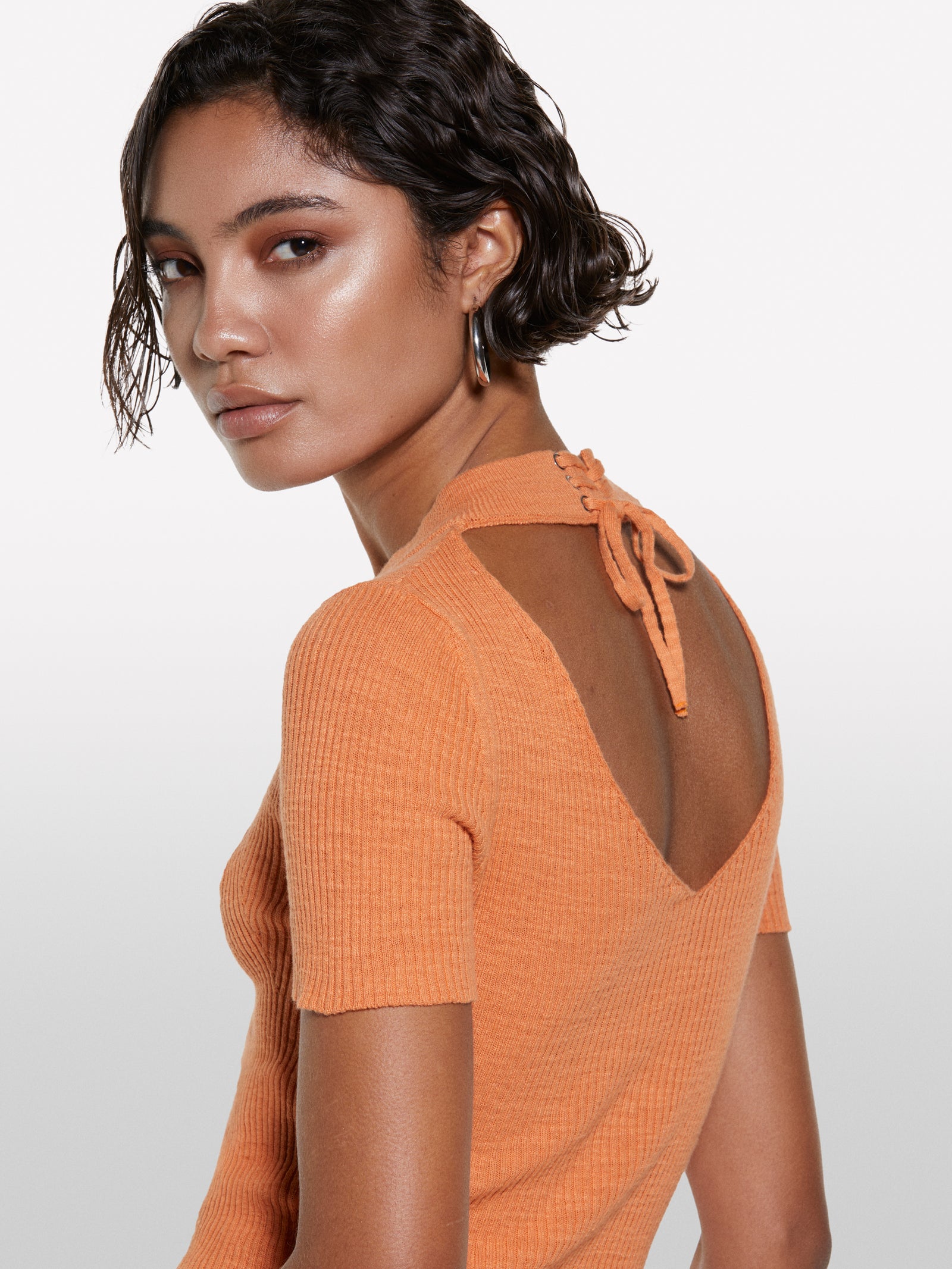 Orange top with porthole on the back